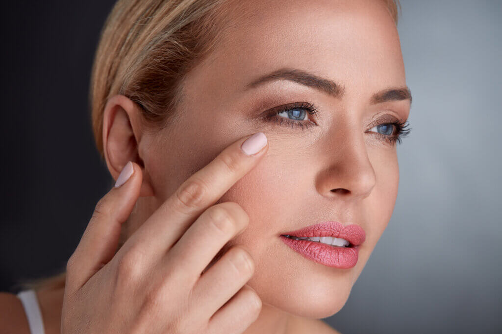 woman looking at the affects of aging on her face