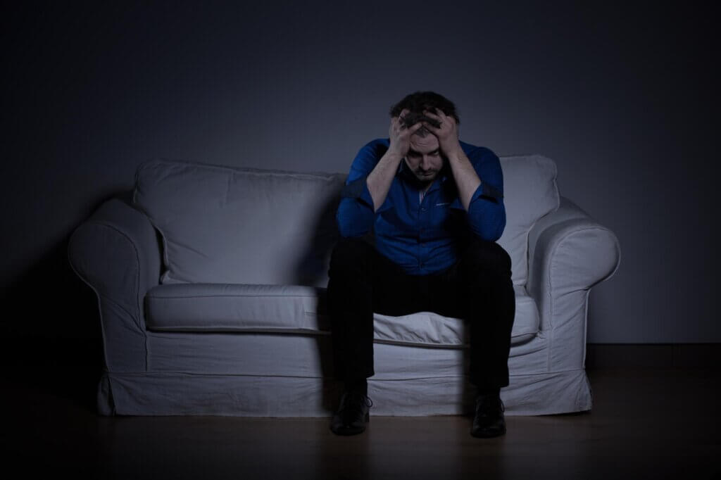 man sitting in a sofa